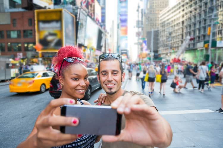 Two tourists taking photos in NYC Times Square