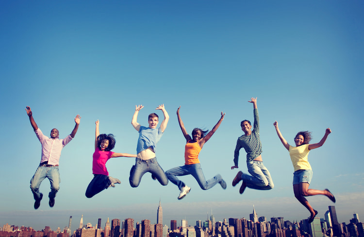 Co-workers Jumping Together in front of New York City skyline