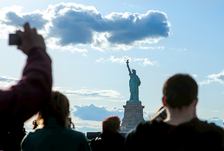 Group of travelers on a ferry to see the Statue of Liberty