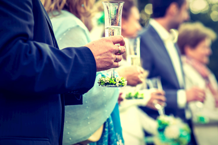 A group of people celebrating an event and drinking champagne