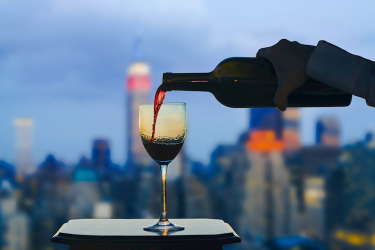 Pouring a glass of wine in front of the New York City skyline