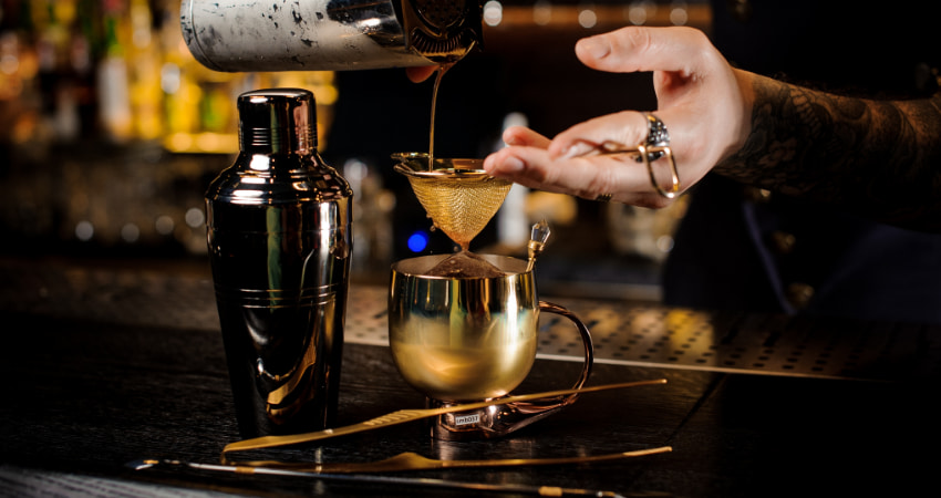 bartender pours a Progibition-style cocktail at a New York City speakeasy