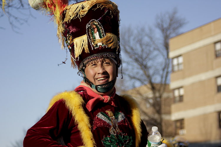 a man smiles while participating in Manhattan's Three Kings Day parade