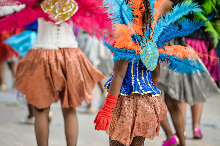 parade participants stroll down the street at the West Indian Day Parade