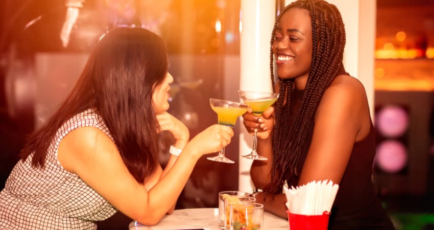two women drinking at a bar