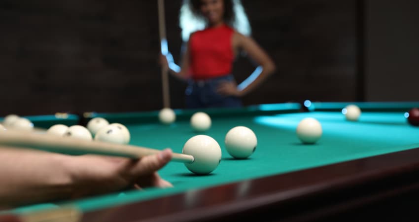 women playing pool at a bar
