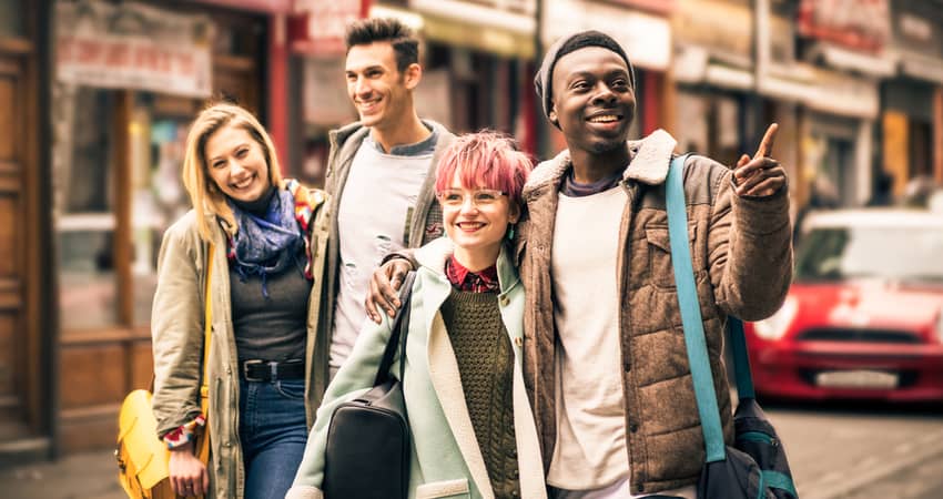 A group of diverse young people sightseeing in the city.