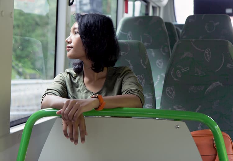 Woman looking out window on bus