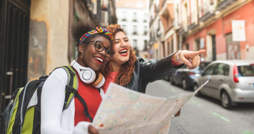 Two women with a map walk the streets on New York City