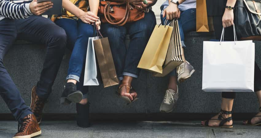 Close up of a group of people holding shopping bags