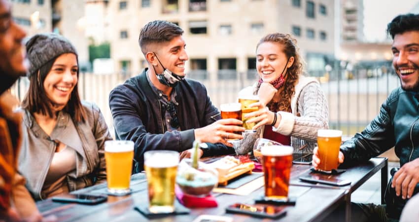 A group of friends enjoying beer out on a patio