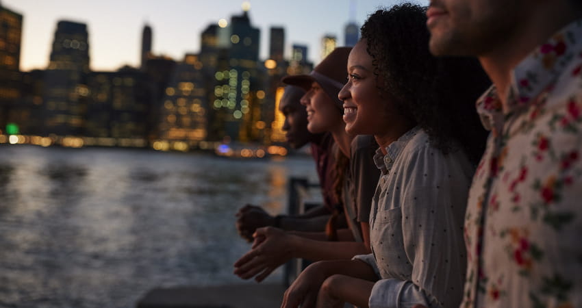A group of friends watch the sun set in Manhattan