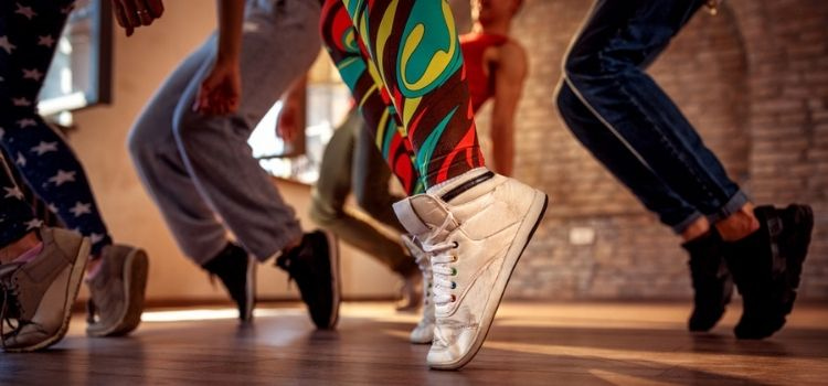 multiple people's feet dancing on a dance floor