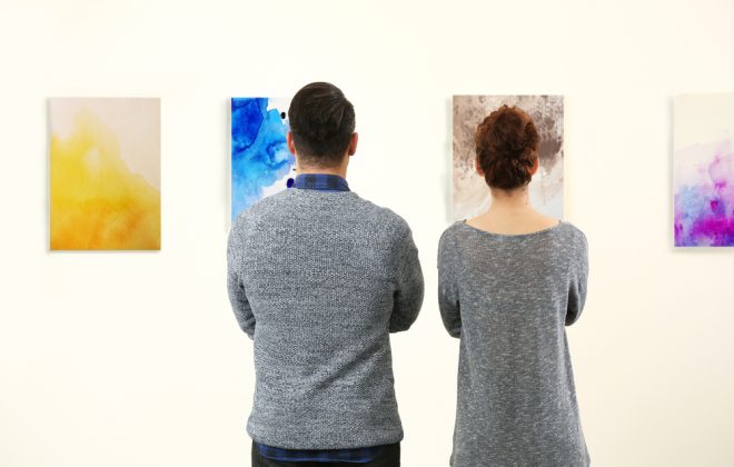 Two people looking at art