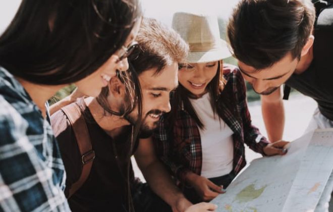 group of friends looking at a map