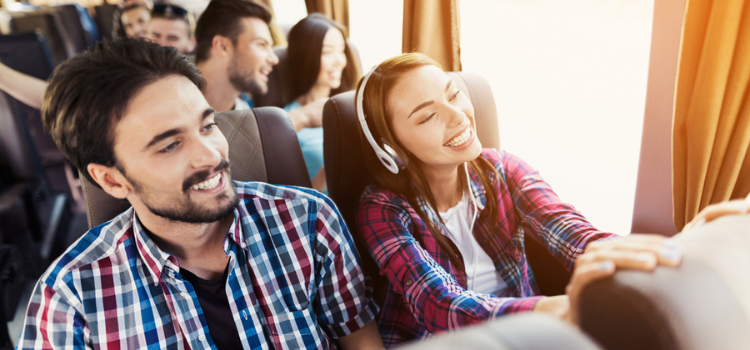 friends sitting on a charter bus together